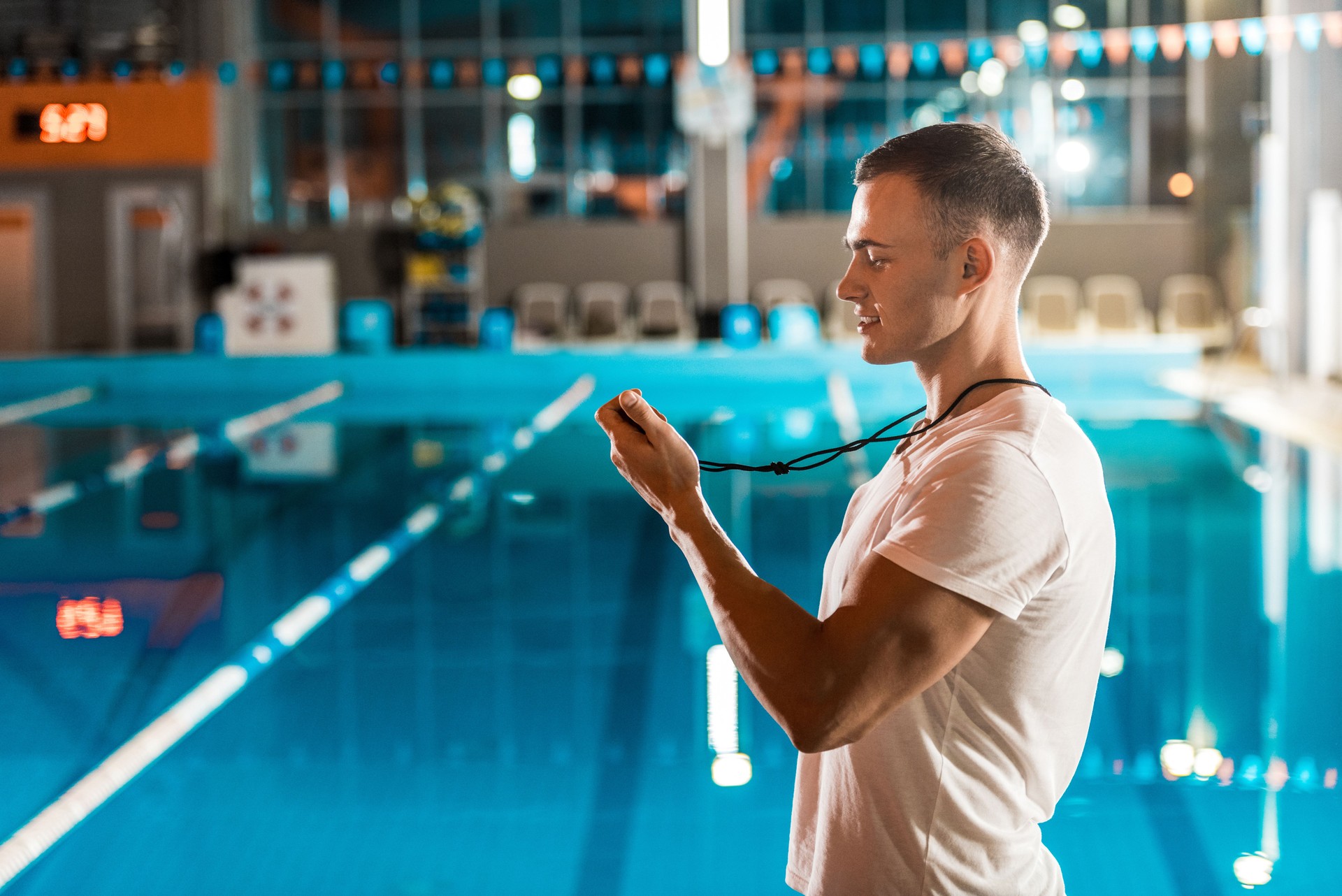 swim coach with stopwatch