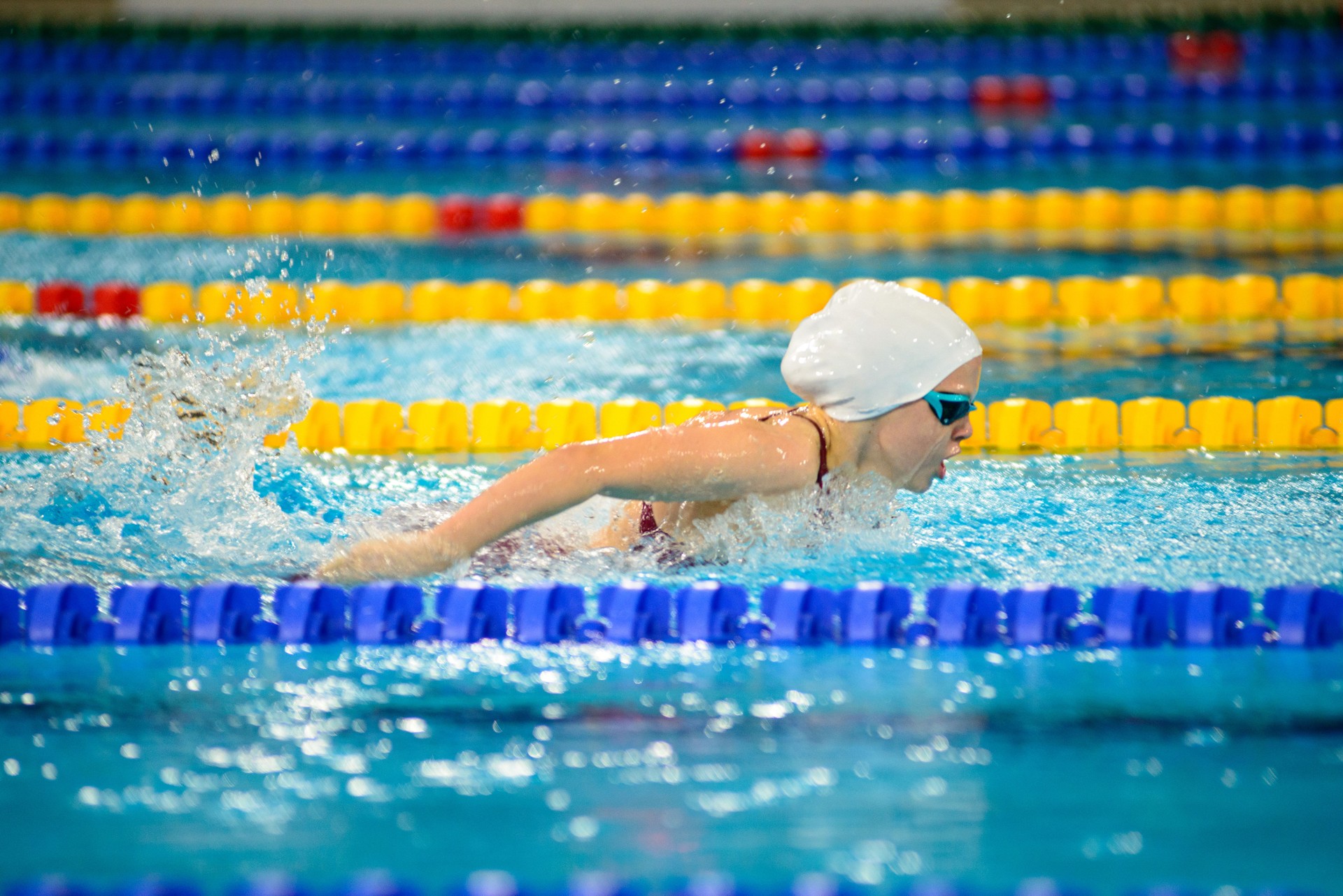 Swimmer girl swims butterfly swimming style in the pool